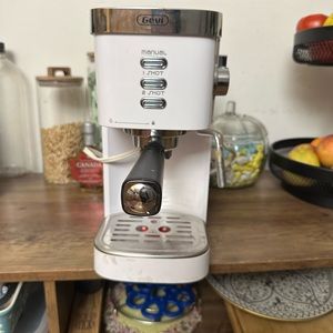 Gently used white espresso maker, with milk frother.